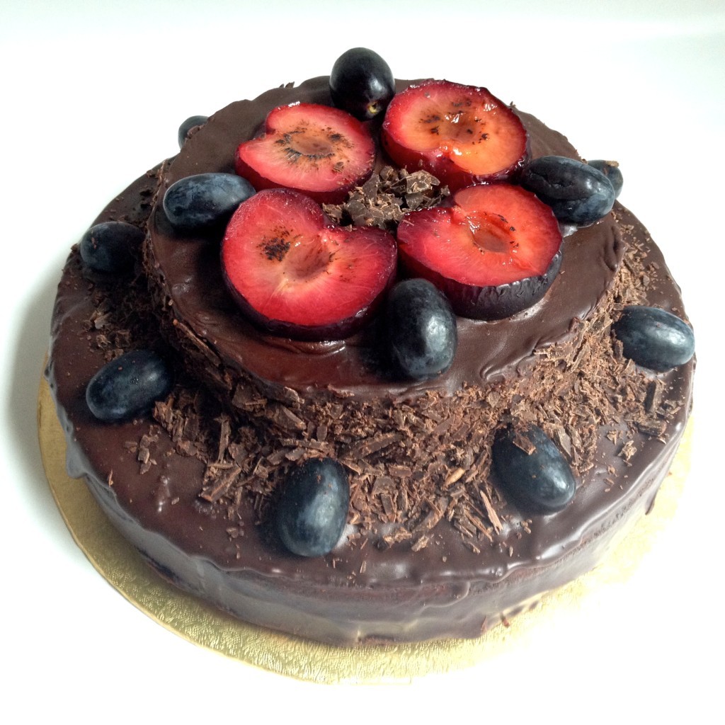 Chocolate amaretto cake decorated with sugar glazed fruits